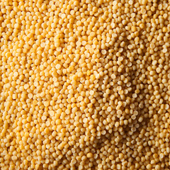 Couscous porridge background with grains, yellow texture