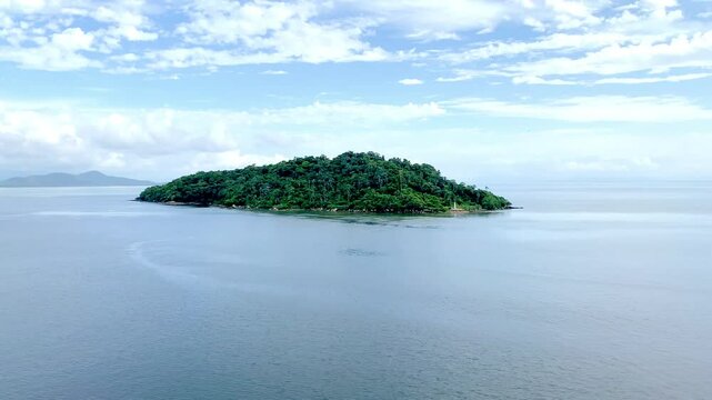 View of a small island filmed aboard a cruise ship upon arrival at the port of Paranagu&aacute; in Brazil. Special attention is paid to the intact nature and the difference in tones in the water due to disti