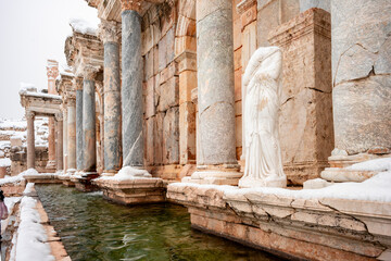 Fototapeta premium o visit the sprawling ruins of Sagalassos, high amid the jagged peaks of Ak Dag, is to approach myth: the ancient ruined city set in stark . Sagalassos Ancient City under the snow on a winter day.