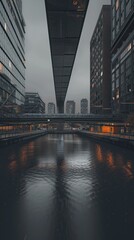 Obraz premium Modern city canal with bridge at dusk.