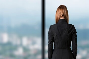 Fototapeta premium Caucasian female business professional in office looking out window