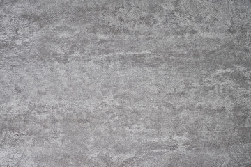 Textured surface with a gray, concrete-like appearance. The texture is uniform but has subtle variations in shading and pattern, giving it a slightly rough and weathered look.