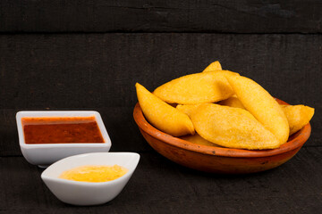 Colombian empanada with spicy sauce 