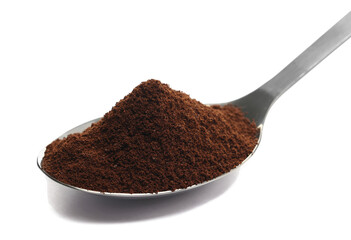 Pile of powder instant coffee in metal spoon isolated on white background, clipping path