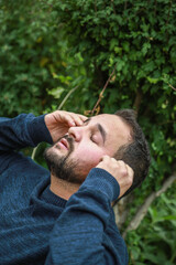 Exhausted Man Relaxing Near A Tree 