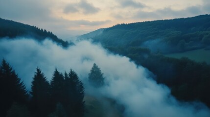 Fototapeta premium Aerial View of Smoke Rising from Mountainside at Dusk