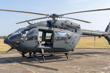 Gray painted modern H145M military transport helicopter stationary on the ground