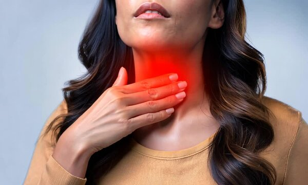Sore throat, tonsillitis, inflammation. Woman with sore throat, inflamed tonsils from flu symptoms.