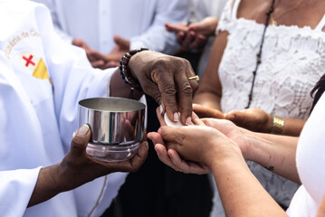 Catholics are seen receiving the host during mass on the last Friday of 2024. Bonfim Church,...