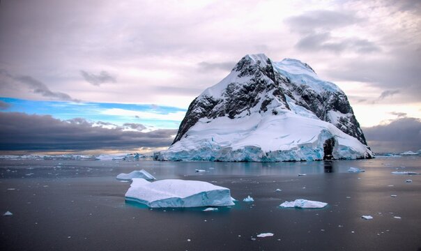 Fascination Antarctica with ice floe in the Arctic sea and a mountain in the background