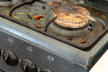 a dirty old gas stove in grease and soot