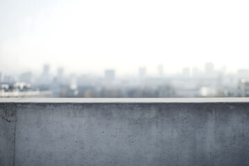 Empty concrete rooftop with city skyline background