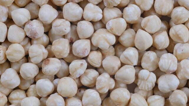 Top down view. A pile of shelled white hazelnut kernels. Slider shot. Food, nutrition, healthy eating, snacks, ingredient concepts. 4k