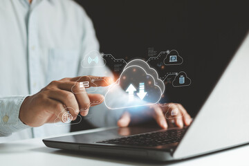 Businessman use laptop computer and hand pointing on virtual cloud computing diagram. Cloud...
