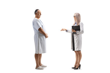 Female doctor explaining medical procedure to a mature male patient in a hospital gown