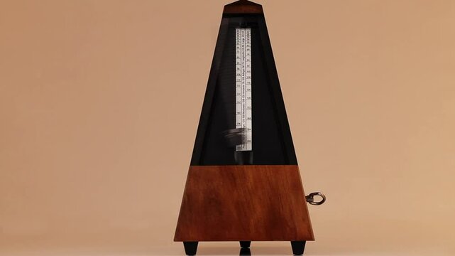Wooden Mechanical Metronome With Metal Arm Moving At Allegro Tempo 
