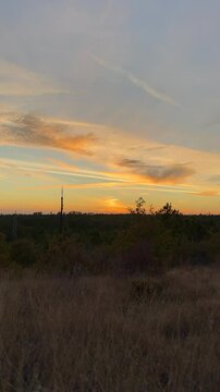 Golden Horizon at Dusk. A peaceful golden sunset over the hills with vibrant skies, creating a tranquil mood. Perfect for motivational text overlays and inspirational content.