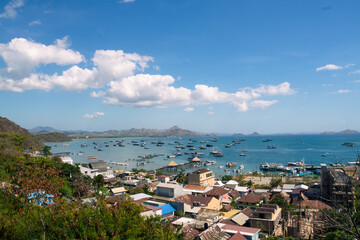 Panoramic view of Labuhan Bajo harbor with boats and ships docking in pier, Flores, Indonesia