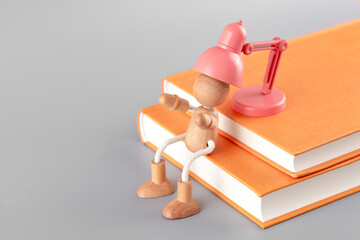 The wooden man is being charged by the book