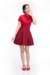 Full body portrait of joyful beauty Asian woman in red Cheongsam Chinese traditional dress celebrating and announcing isolated on white background.