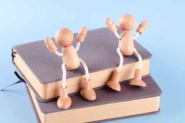 Happy wooden people and books