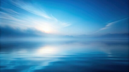 Obraz premium Serene Waterscape Misty Morning on a Calm Lake with Distant Mountains and a Peaceful Sunrise