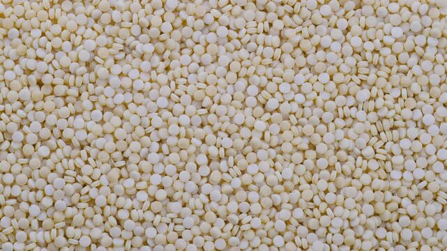 Top down view. Heap of raw dry couscous (kuskus) groats, cereals. Slider shot. Texture of grains. Cooking, whole grains, traditional cuisine, food-related themes. 4k