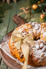 Bolo Rainha, a celebratory ring cake garnished with almonds, nuts, dried fruits, fruits raisins and dusted with powdered sugar, perfect for festive occasions like Christmas and New Year.