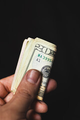 A hand paying with cash