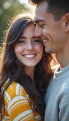 Obraz premium A young couple, a woman with long dark hair and a man with short dark hair, share a warm embrace, radiating happiness. Their genuine smiles and close proximity create an intimate atmosphere