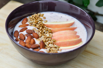 smoothie bowl , strawberry smoothie or strawberry yogurt with apple , sunflower seed and almond