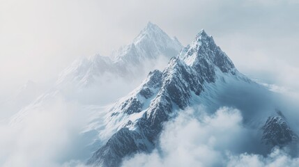Naklejka premium Majestic snow-capped mountains shrouded in mist and clouds, evoking tranquility and awe.