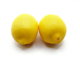 A vibrant yellow lemon sits on a pristine white background