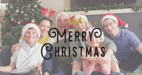 Image of christmas greetings text over caucasian family in santa hats at christmas table © vectorfusionart