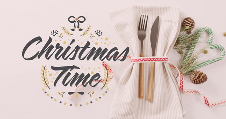 Image of christmas greetings text over place setting and decorations © vectorfusionart