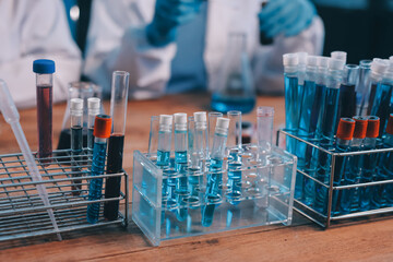 Blood test in the laboratory. Laboratory assistant working with the dispenser. Vacuum tubes with blood.