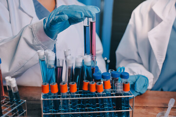 Blood test in the laboratory. Laboratory assistant working with the dispenser. Vacuum tubes with...