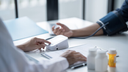 Medical Examination Doctor Conducting Blood Pressure Test on Patient for Diagnosisใ