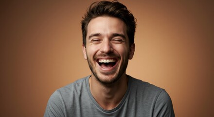 Fototapeta premium Portrait of a laughing man against a warm background