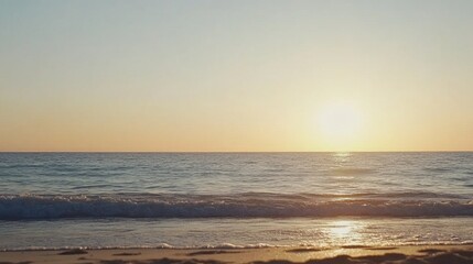 Fototapeta premium Serene Sunset Over Calm Ocean Waves on Tranquil Beach Shoreline