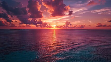 Mesmerizing golden sky reflecting across vibrant turquoise waters in the Maldives, creating a serene tropical paradise under a radiant sunset