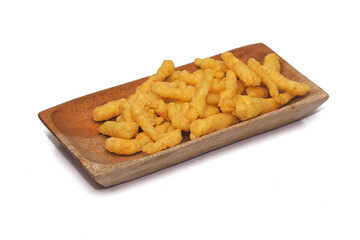 Cheese Puff Snacks on a wooden plate isolated on white background