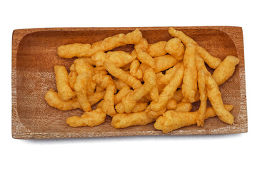 Cheese Puff Snacks on a wooden plate isolated on white background
