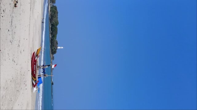 Boat with indonesian flag and blue sky in Santolo Beach, Garut