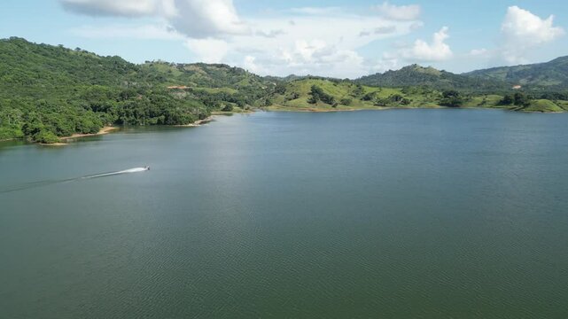 Aerial view of the reservoir Presa de Hatillo near Cotui in the S&aacute;nchez Ram&iacute;rez province of the Dominican Republic with a jet ski crossing the lake