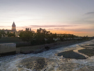 Sunset over the historic Trujillo Bridge and the Rimac River in Lima, Peru