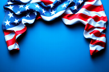 A vibrant American flag drapes against a blue background, showcasing its iconic red, white, and blue colors, symbolizing patriotism and national pride. copy space