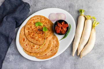 Mooli paratha is a stuffed Indian flatbread made with grated radish, whole wheat flour, and spices, offering a flavorful, nutritious, and wholesome meal.