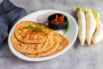 Mooli paratha is a stuffed Indian flatbread made with grated radish, whole wheat flour, and spices, offering a flavorful, nutritious, and wholesome meal.