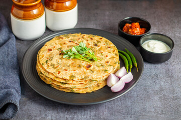 Methi paratha is a savory Indian flatbread made with fenugreek leaves, whole wheat flour, spices, and ghee, offering a flavorful, aromatic, and nutritious meal.